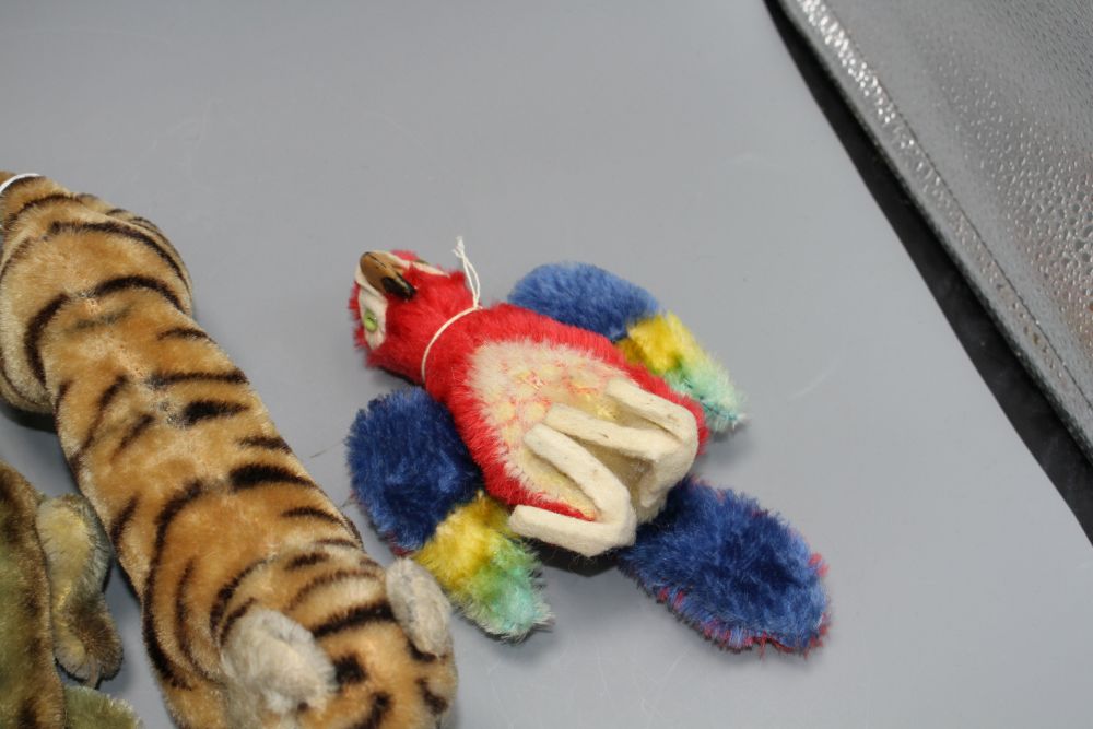 Two 1950s Steiff tigers, a crocodile, a parrot and a lion glove puppet